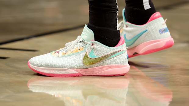 Light green and pink Nike LeBron shoes.